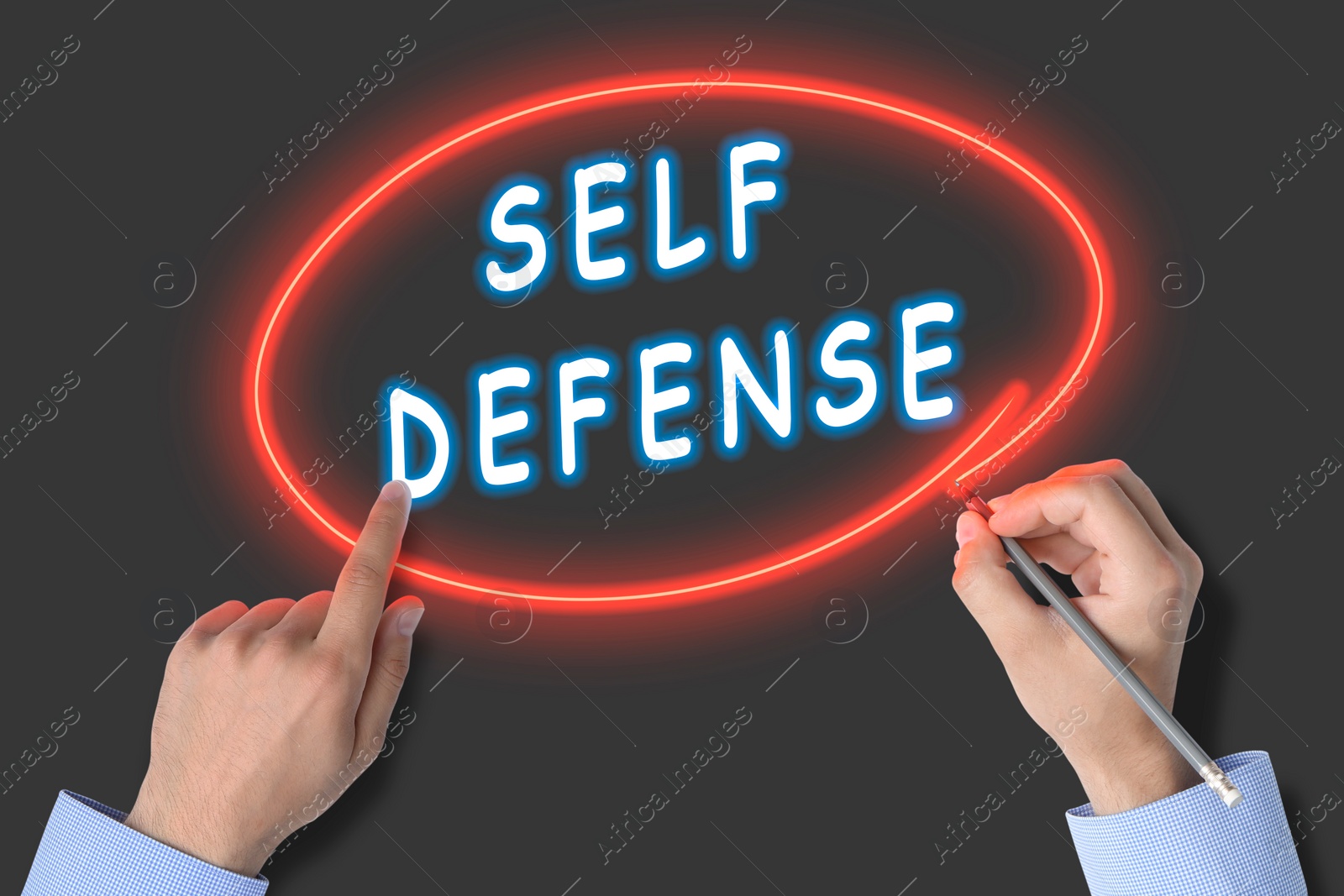 Image of Man circling words Self Defense with pencil on glass board, closeup. Neon effect