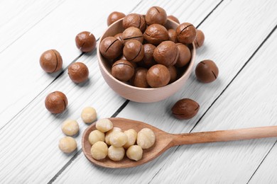 Photo of Delicious organic Macadamia nuts on white wooden table