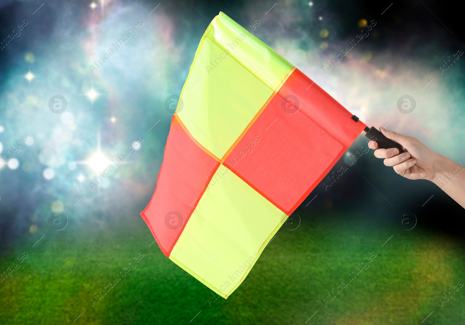 Image of Referee holding linesman flag at stadium, closeup