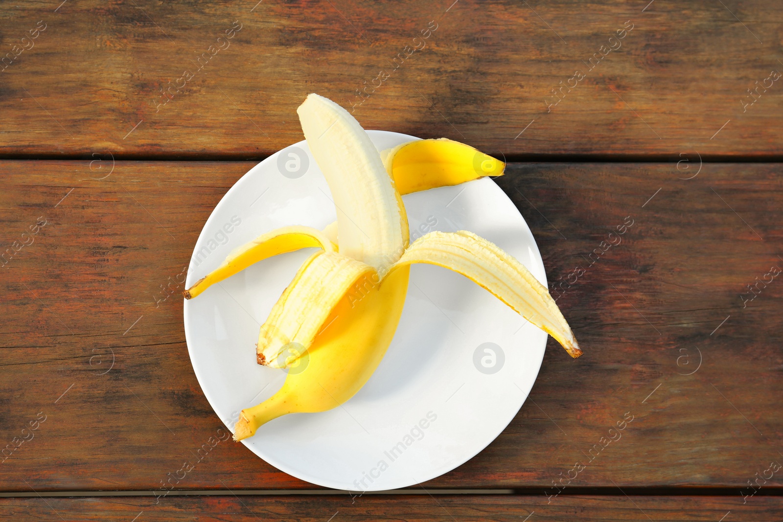 Photo of One delicious banana on wooden table, top view