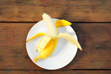 Photo of One delicious banana on wooden table, top view