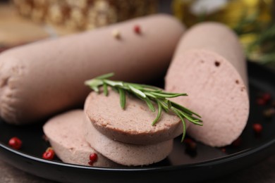 Photo of Delicious liver sausages with rosemary on plate, closeup view