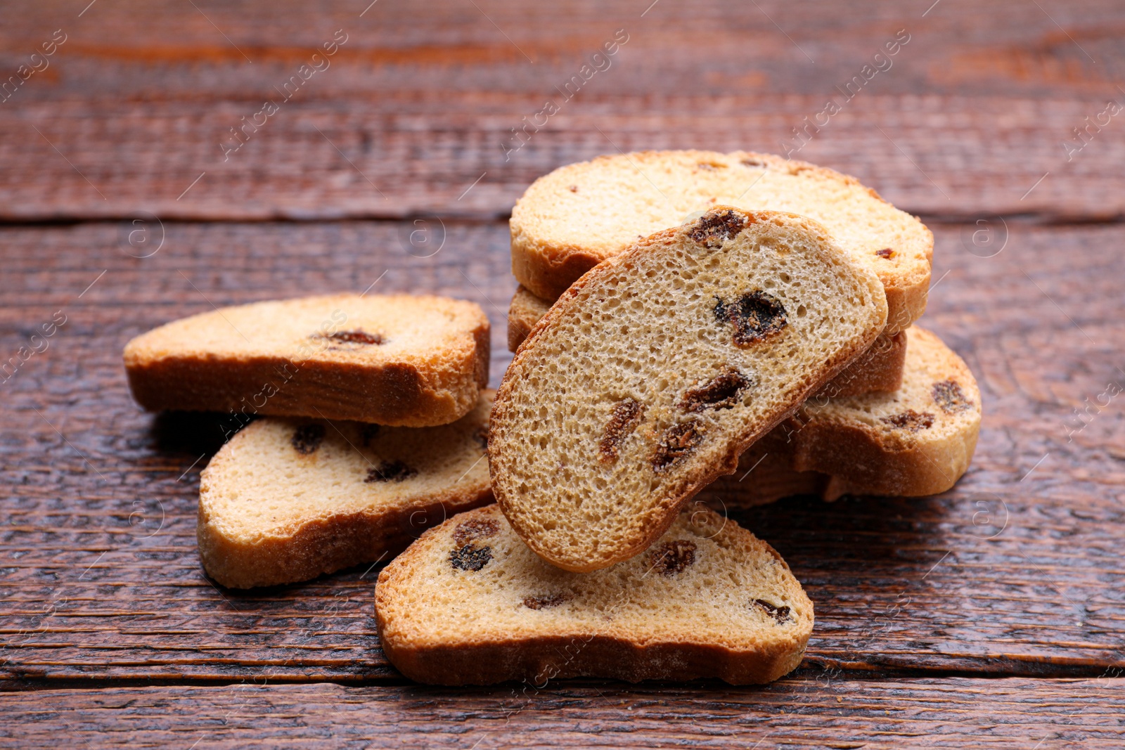 Photo of Sweet hard chuck crackers with raisins on wooden table