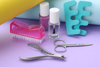 Photo of Set of pedicure tools on color background