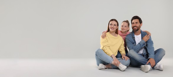 Happy family with child on light grey background, space for text. Banner design