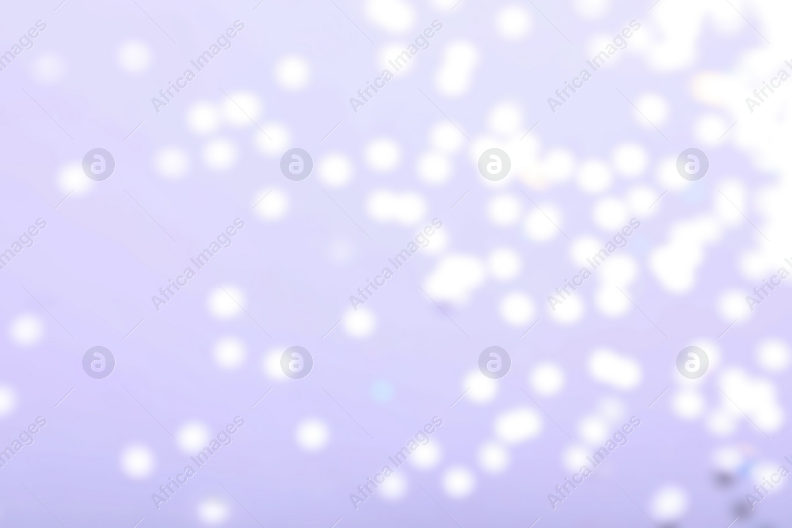 Photo of Blurred view of festive lights on light background. Bokeh effect