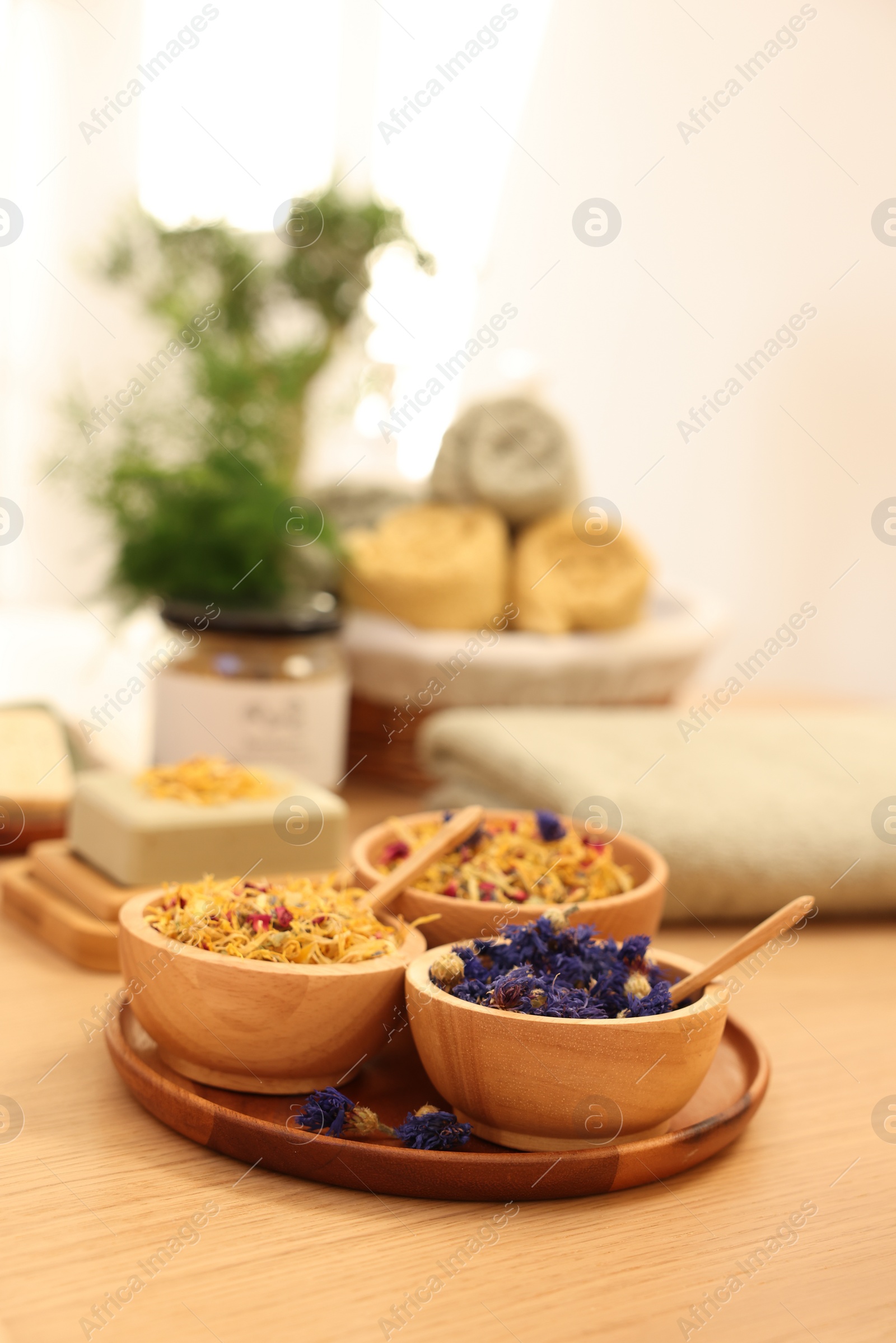 Photo of Dry flowers on wooden table indoors, space for text. Spa time