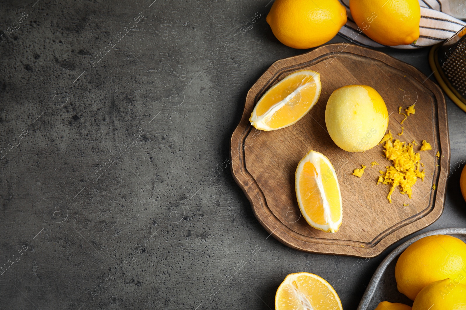 Photo of Lemon zest and fresh fruits on grey table, flat lay. Space for text