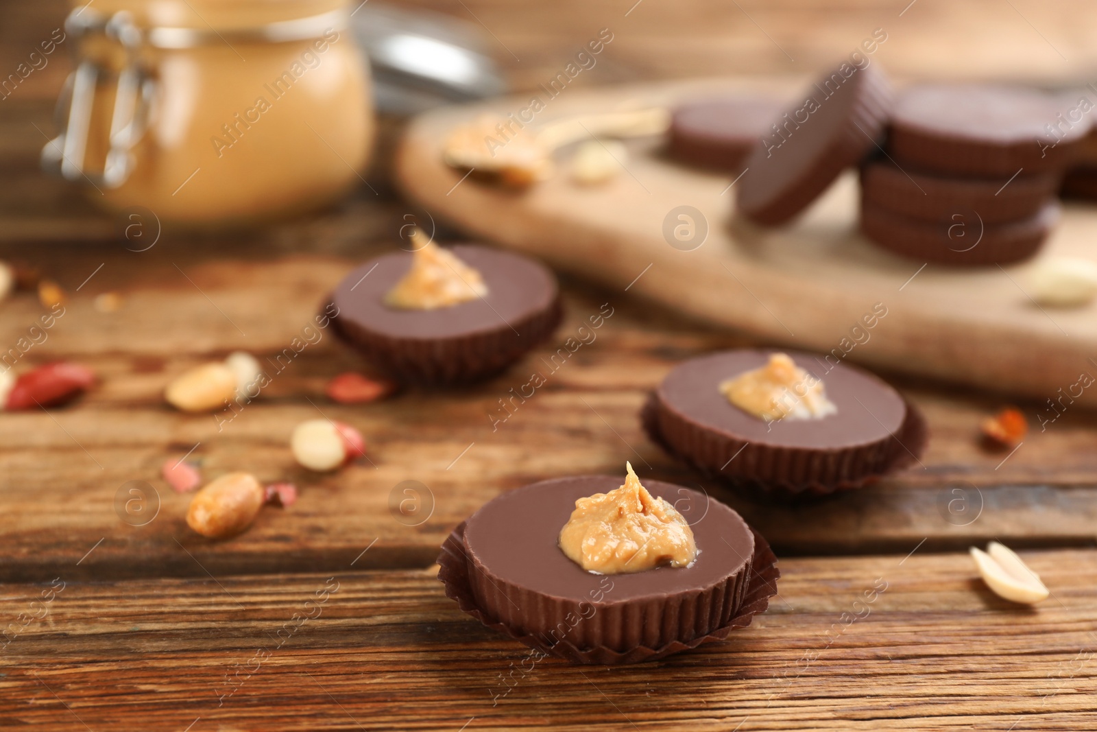 Photo of Delicious peanut butter cups on wooden table