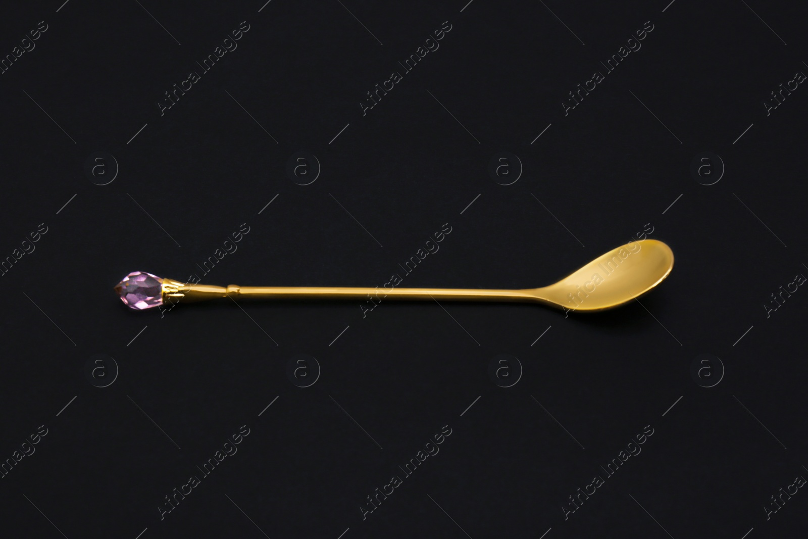 Photo of Shiny luxury gold spoon on black background