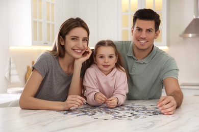 Happy family playing with puzzles at home