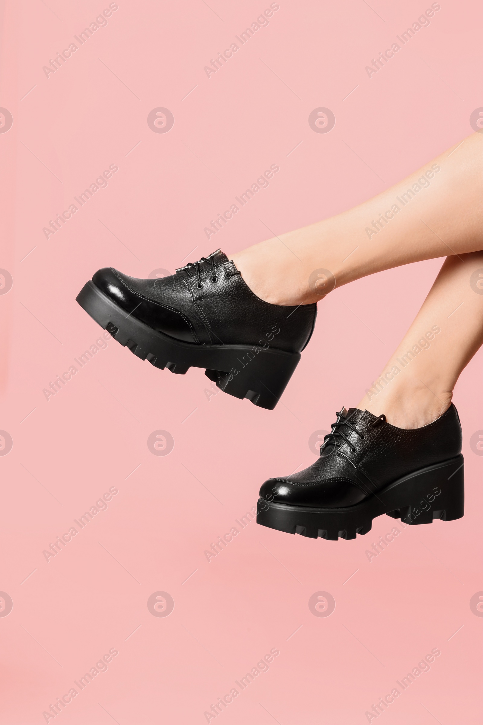 Photo of Woman in stylish shoes on color background, closeup