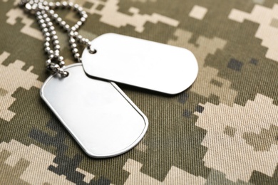 Photo of Military ID tags on camouflage background