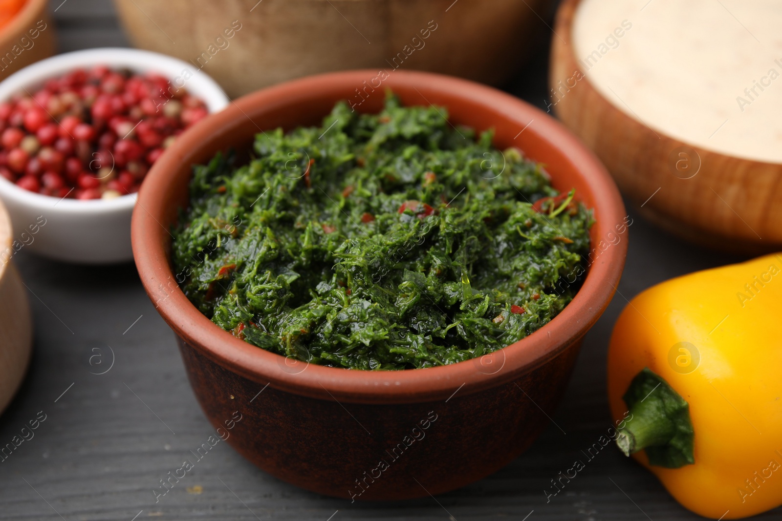 Photo of Fresh marinade in bowl on grey wooden table, closeup