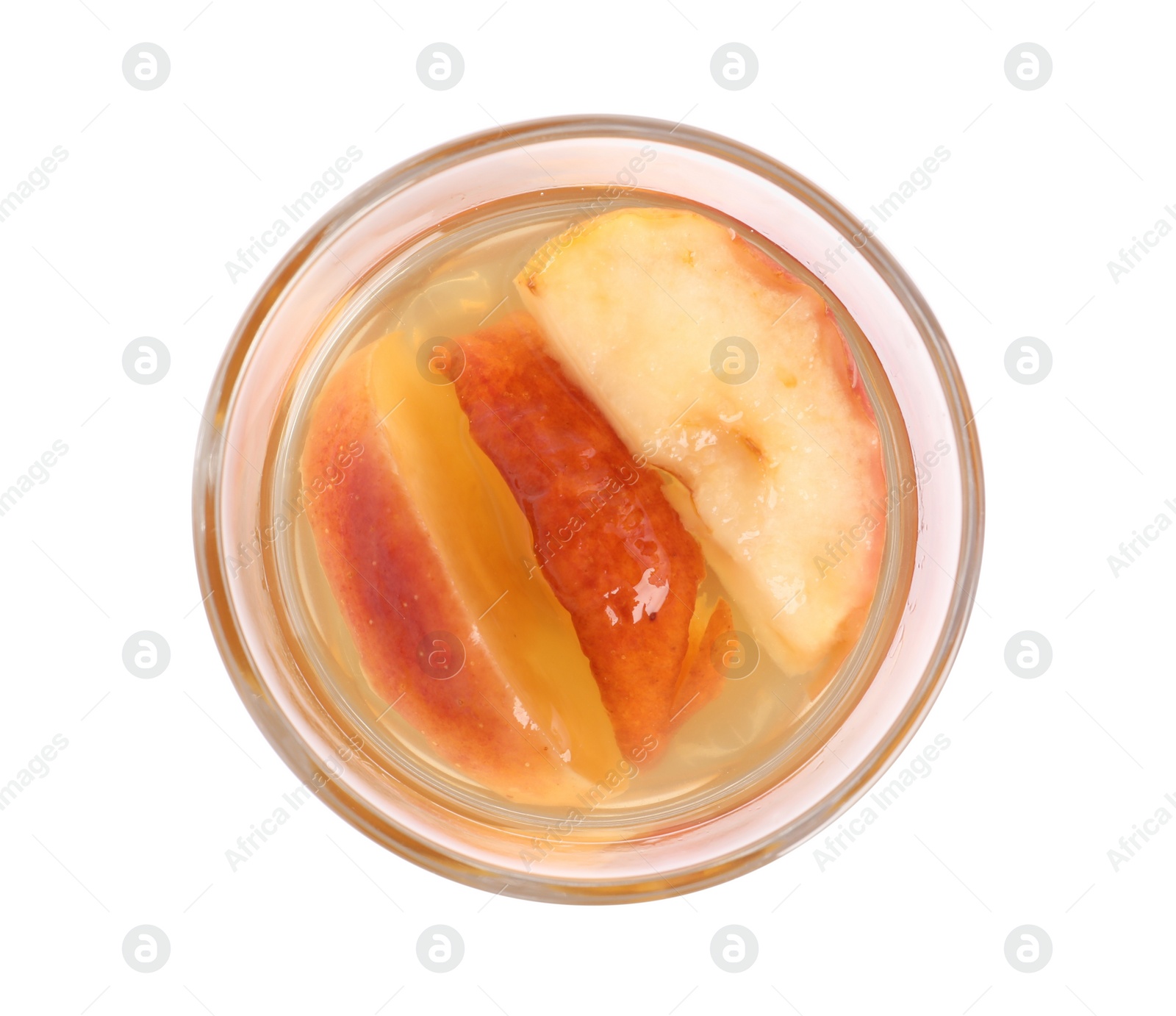 Photo of Delicious compot with dried apple slices in glass on white background, top view