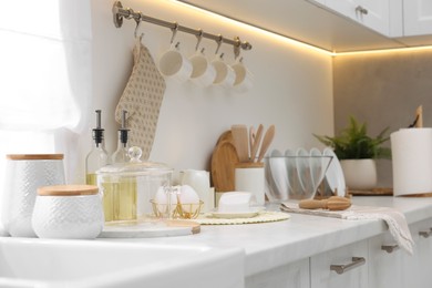 Photo of Set of different utensils and dishes on countertop in kitchen