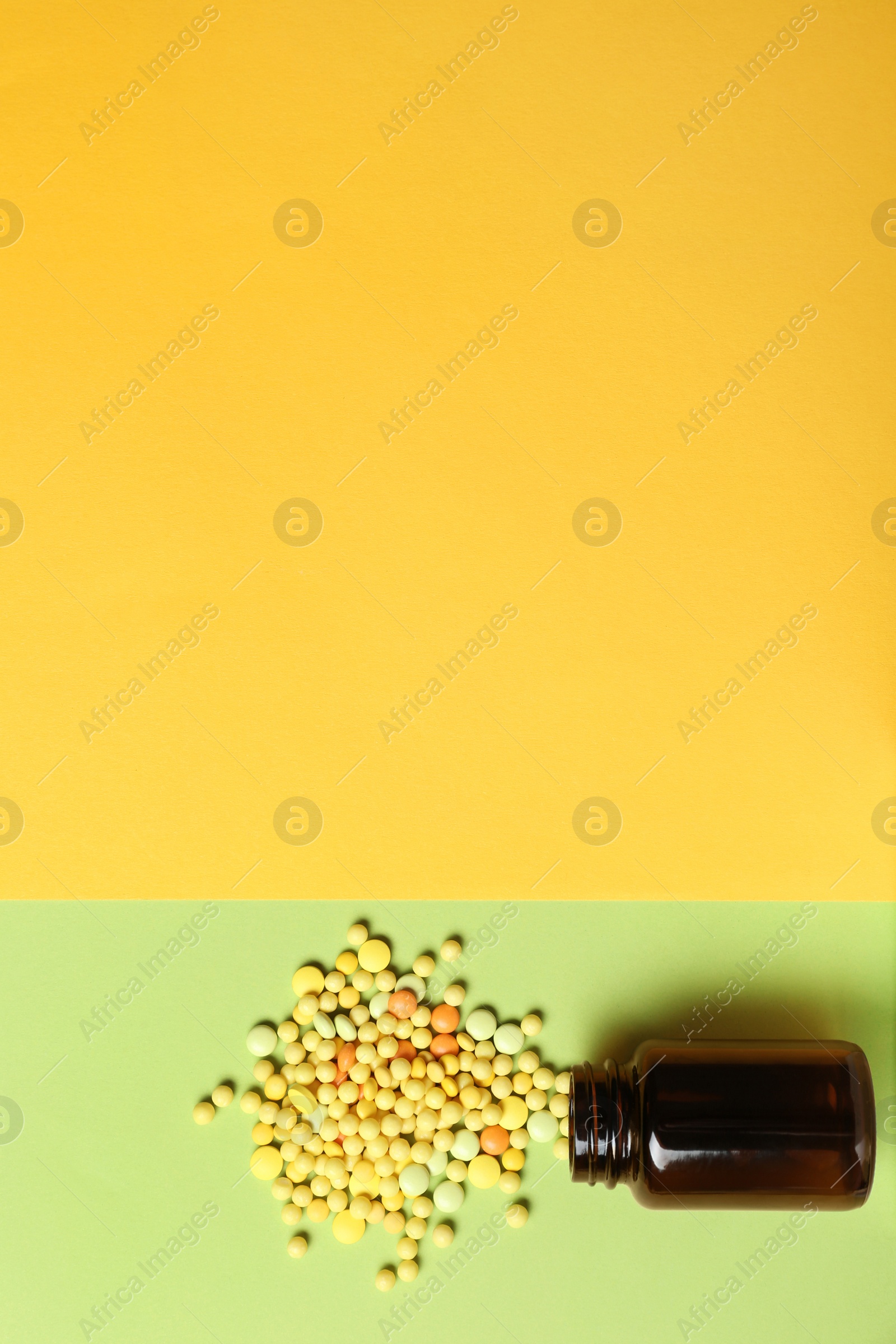 Photo of Bottle with vitamin pills on color background, flat lay. Space for text