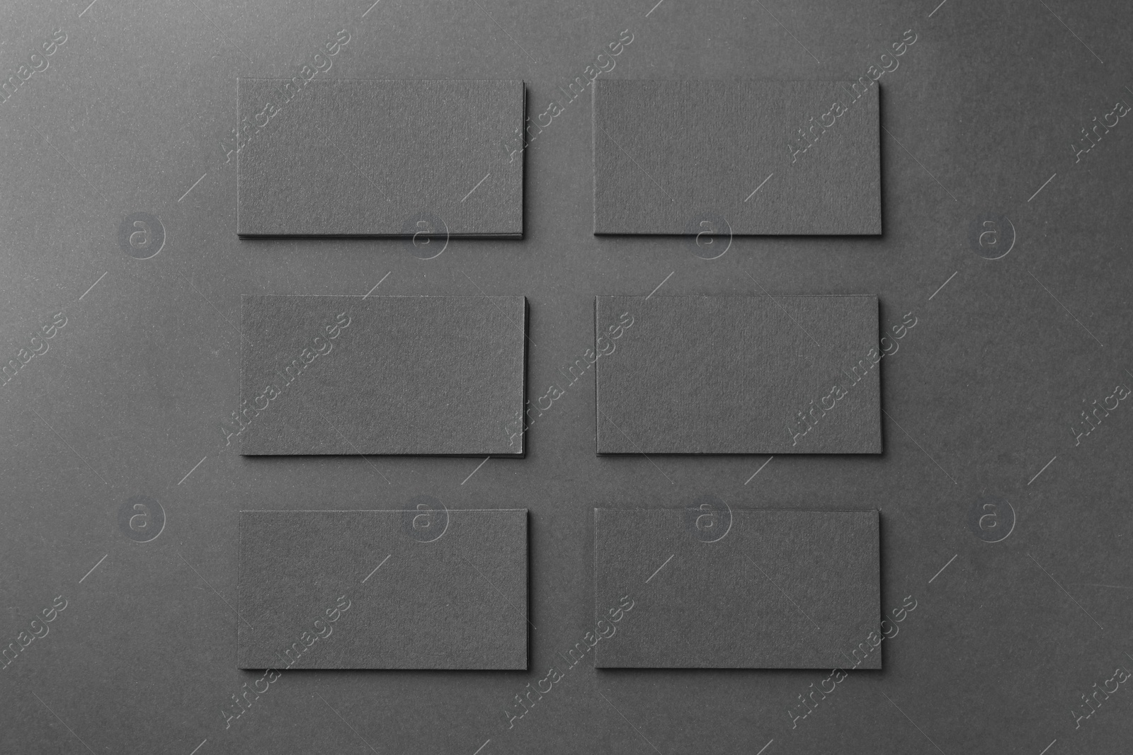 Photo of Blank business cards on black background, flat lay. Mockup for design