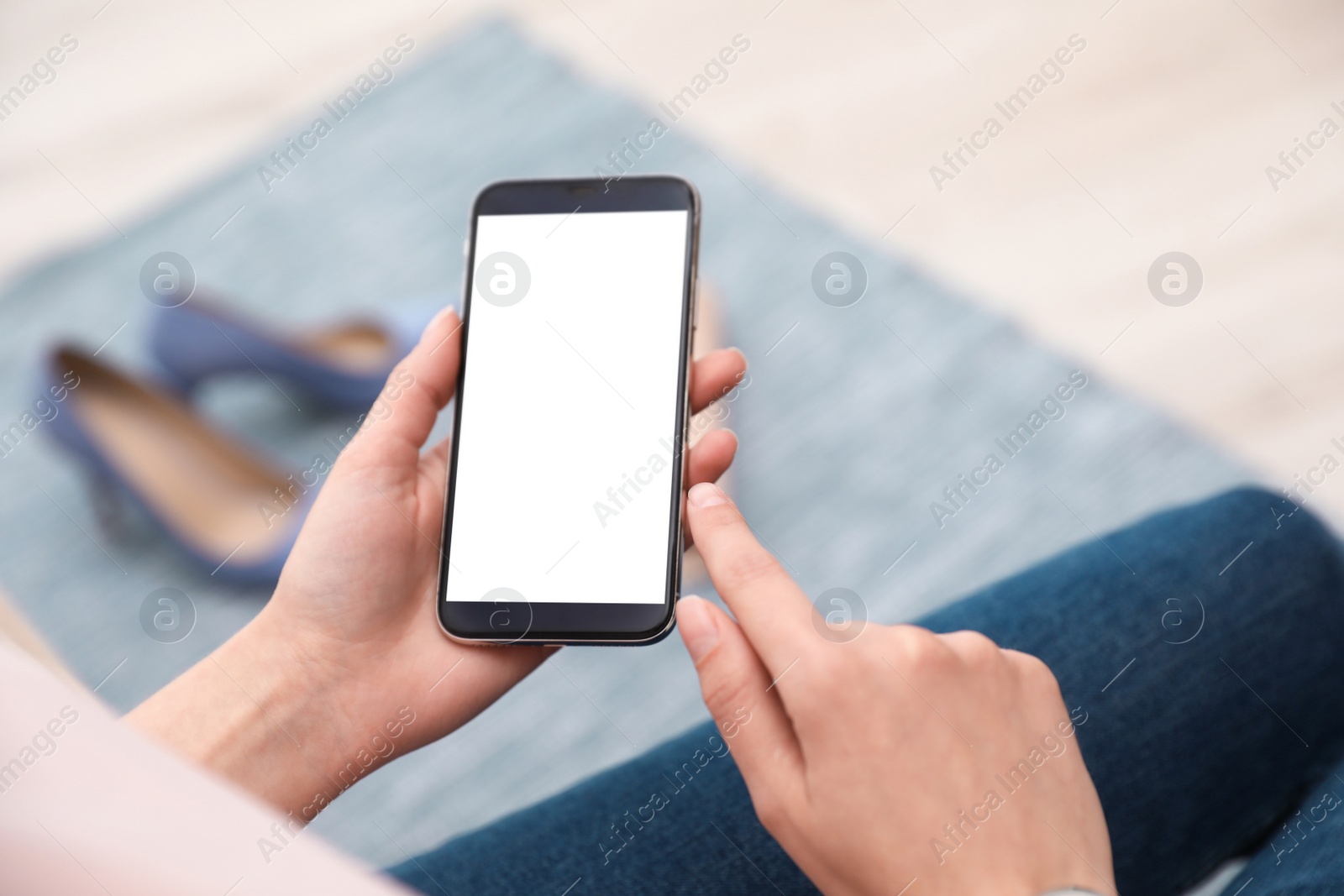 Photo of Woman holding smartphone with blank screen indoors, closeup of hands. Space for text