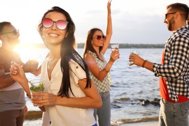 Photo of Woman with friends having fun near river at summer party
