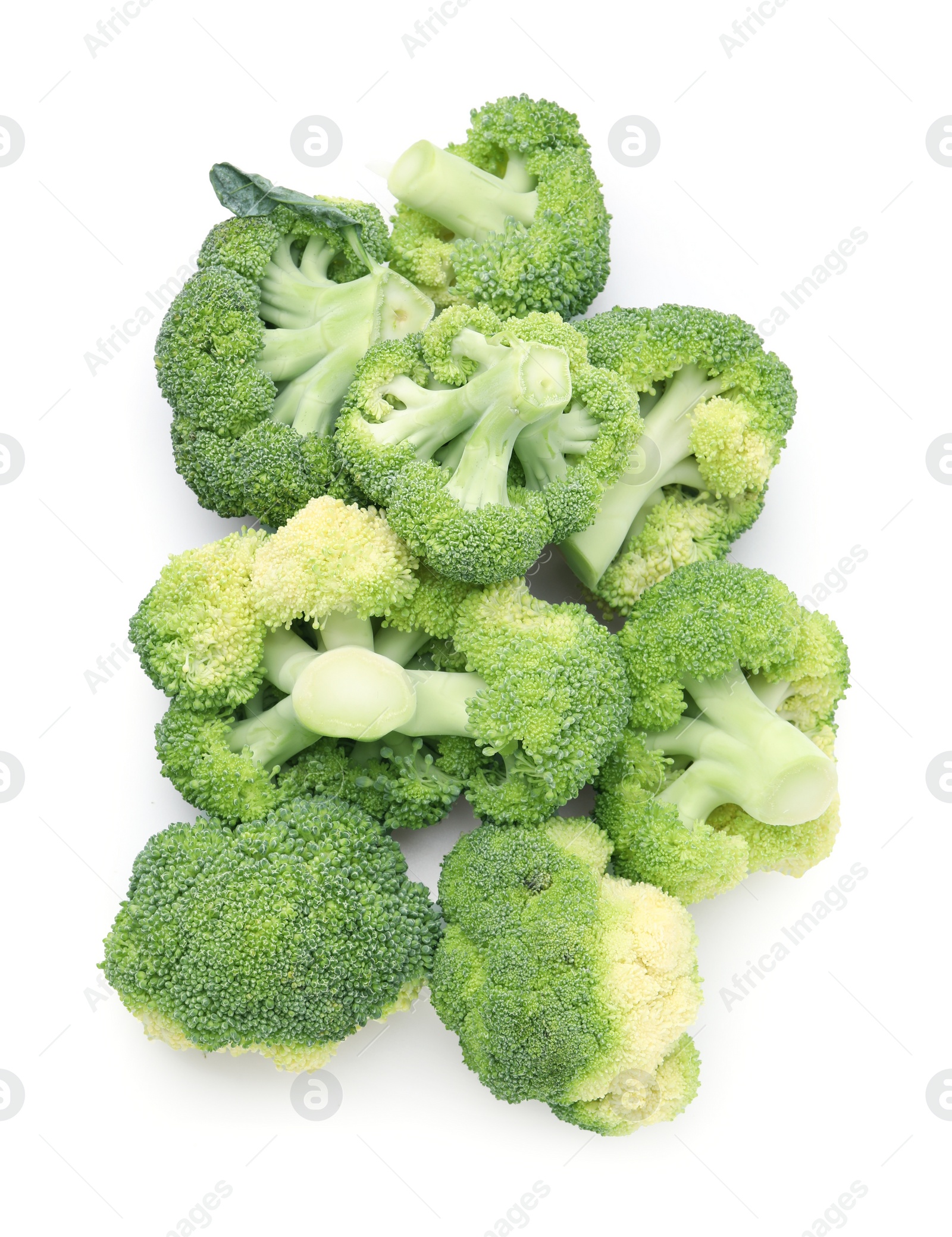 Photo of Pile of fresh raw green broccoli isolated on white, top view