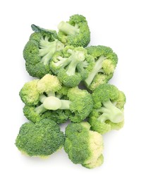 Photo of Pile of fresh raw green broccoli isolated on white, top view