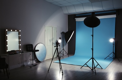 Photo of Modern photo studio interior with professional lighting equipment