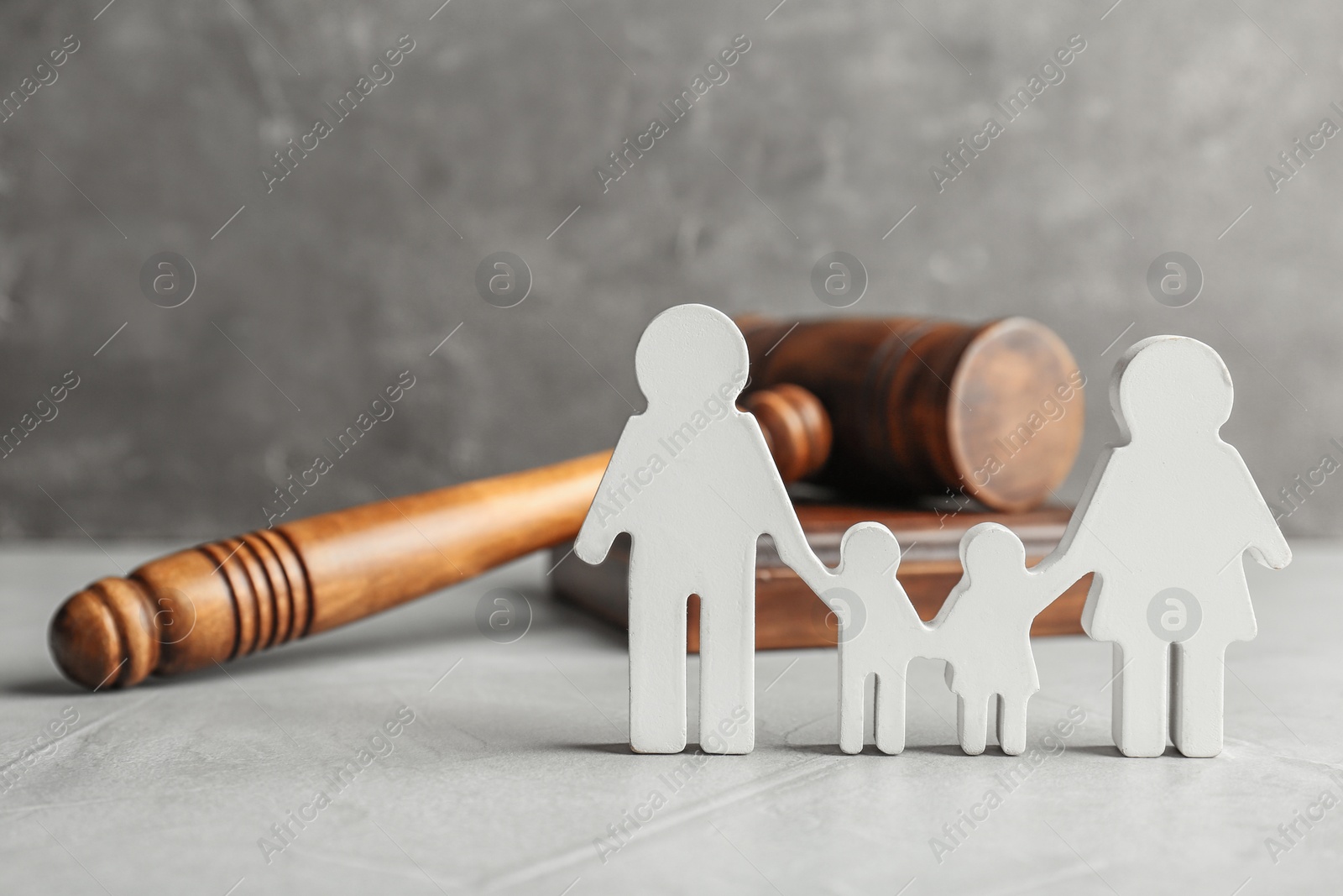 Photo of Family figure and gavel on table. Family law concept