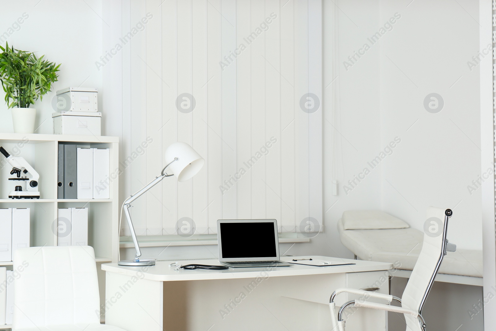 Photo of Doctor's workplace with modern laptop in medical office