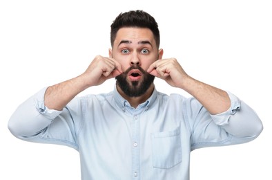 Surprised young man touching mustache on white background