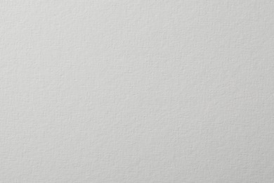 Photo of Texture of white paper sheet as background, closeup