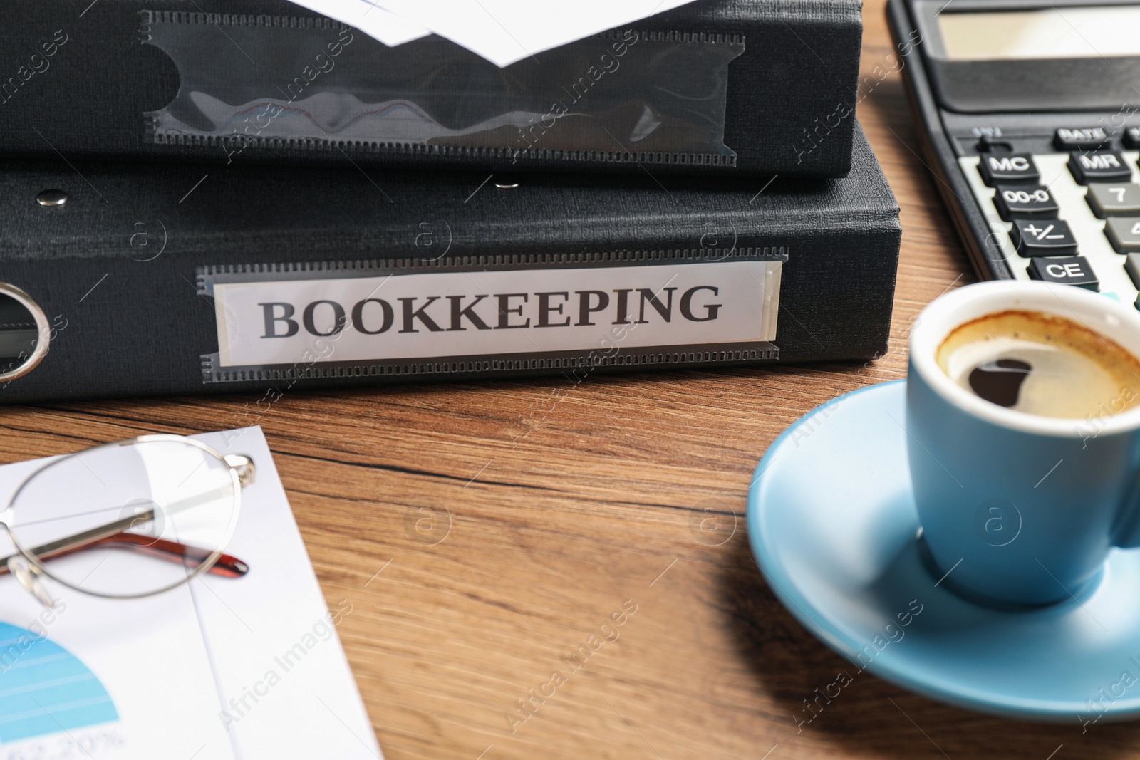 Photo of Bookkeeper's workplace with folders and documents on table