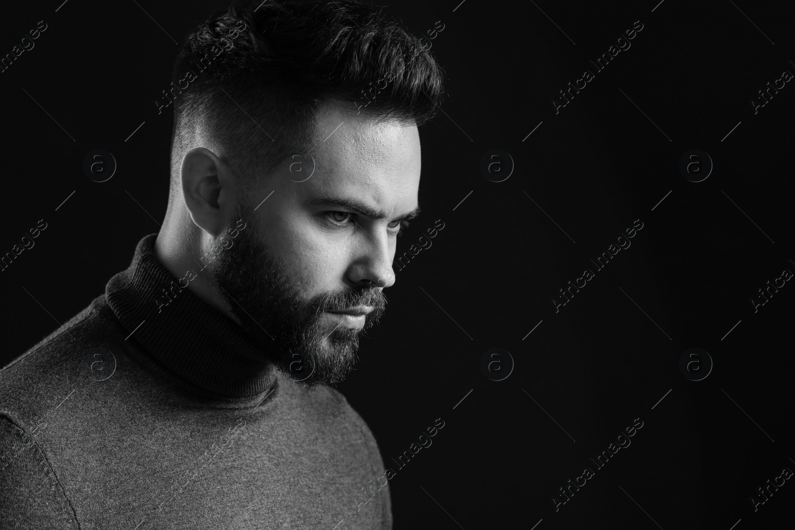 Photo of Portrait of handsome bearded man on dark background, space for text. Black and white effect