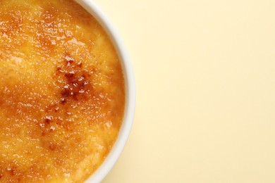 Delicious creme brulee on beige background, top view. Space for text