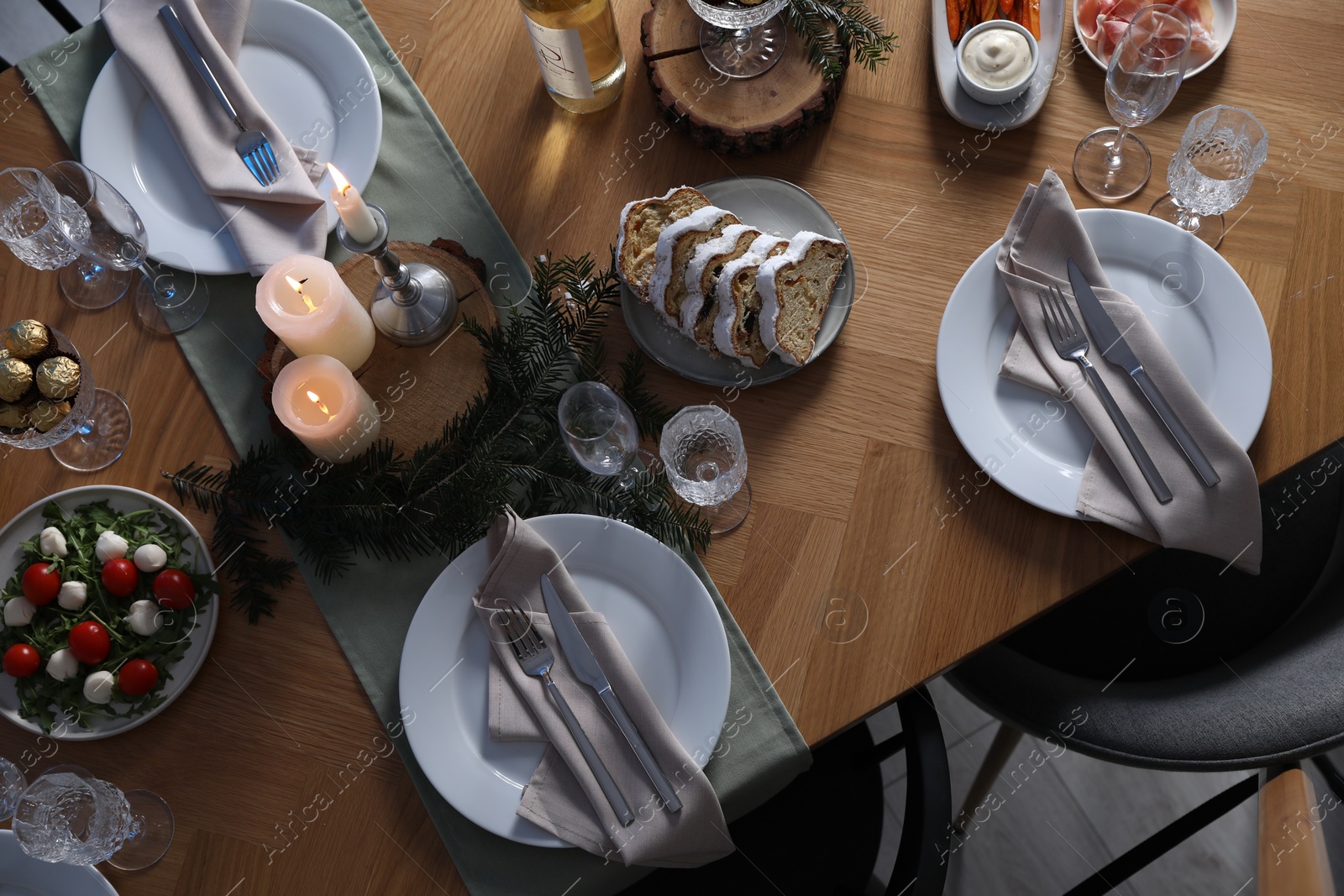 Photo of Christmas table setting with festive decor and dishware, top view