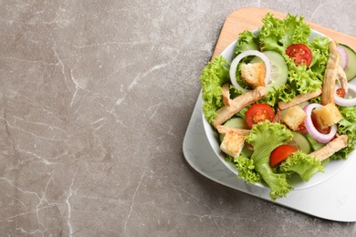 Delicious fresh chicken salad on grey table, top view. Space for text