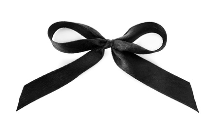 Photo of Black ribbon bow on white background, top view. Funeral symbol