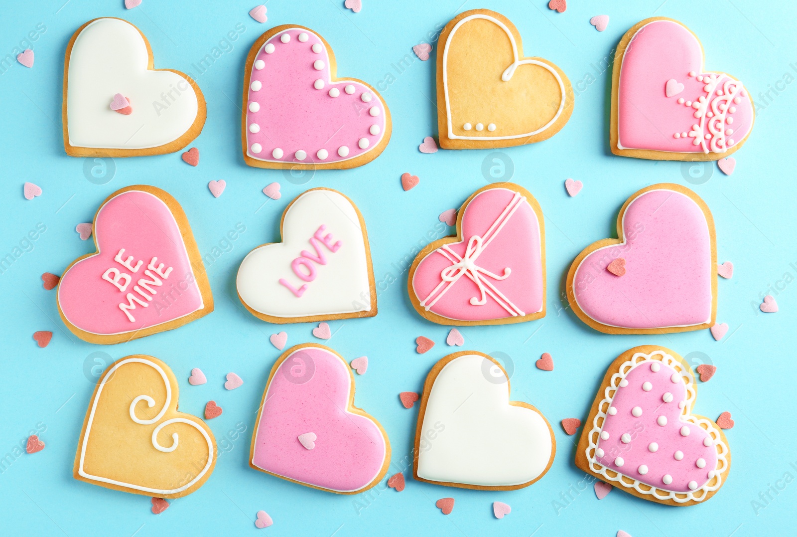 Photo of Composition with decorated heart shaped cookies on color background, top view. Valentine's day treat