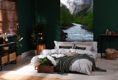 Image of Cozy bedroom interior. Comfortable bed near wall with mountain landscape wallpapers