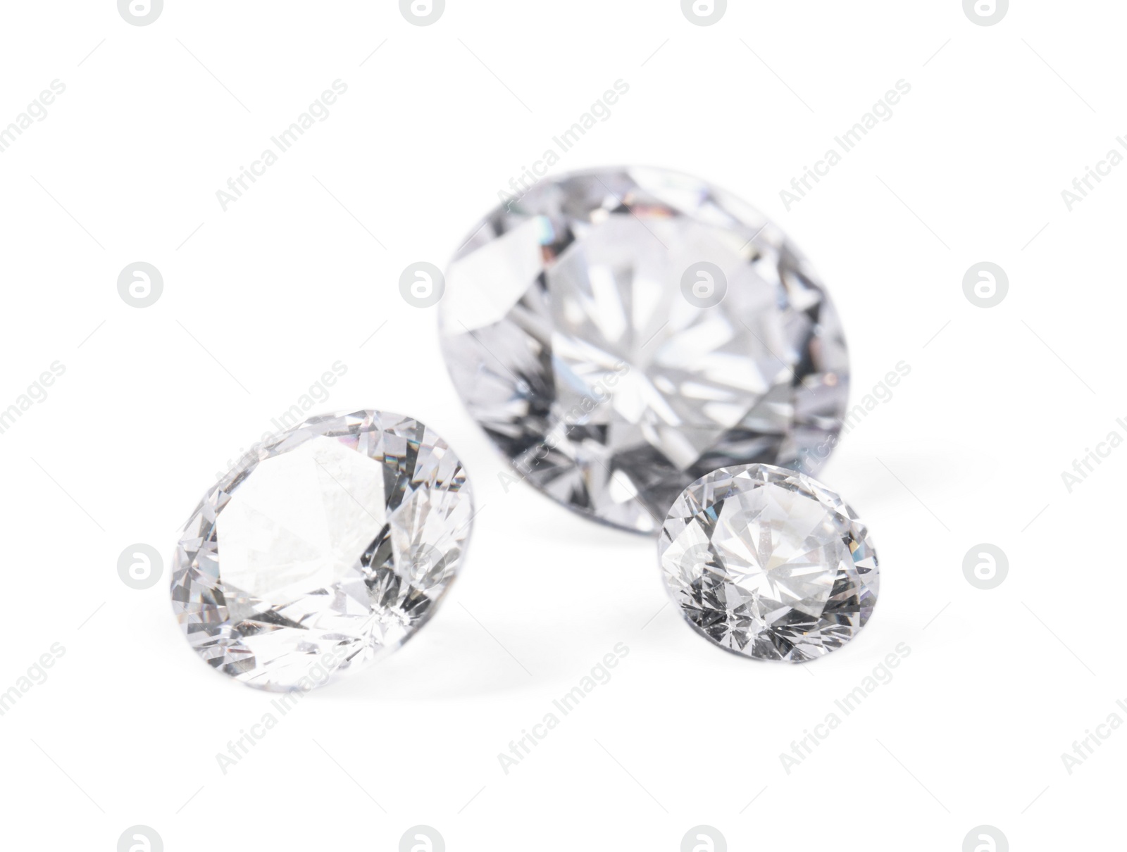 Photo of Three beautiful shiny diamonds isolated on white