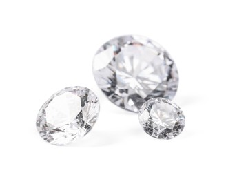 Photo of Three beautiful shiny diamonds isolated on white