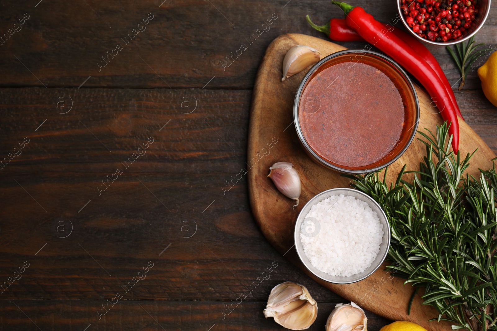 Photo of Fresh marinade and ingredients on wooden table, flat lay. Space for text