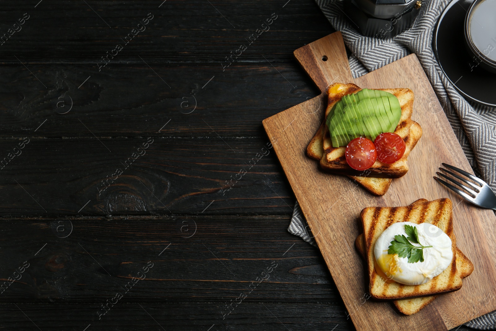 Photo of Delicious poached egg with toasted bread and garnish served on black wooden table, flat lay. Space for text