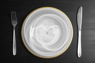 Elegant table setting on dark background, top view