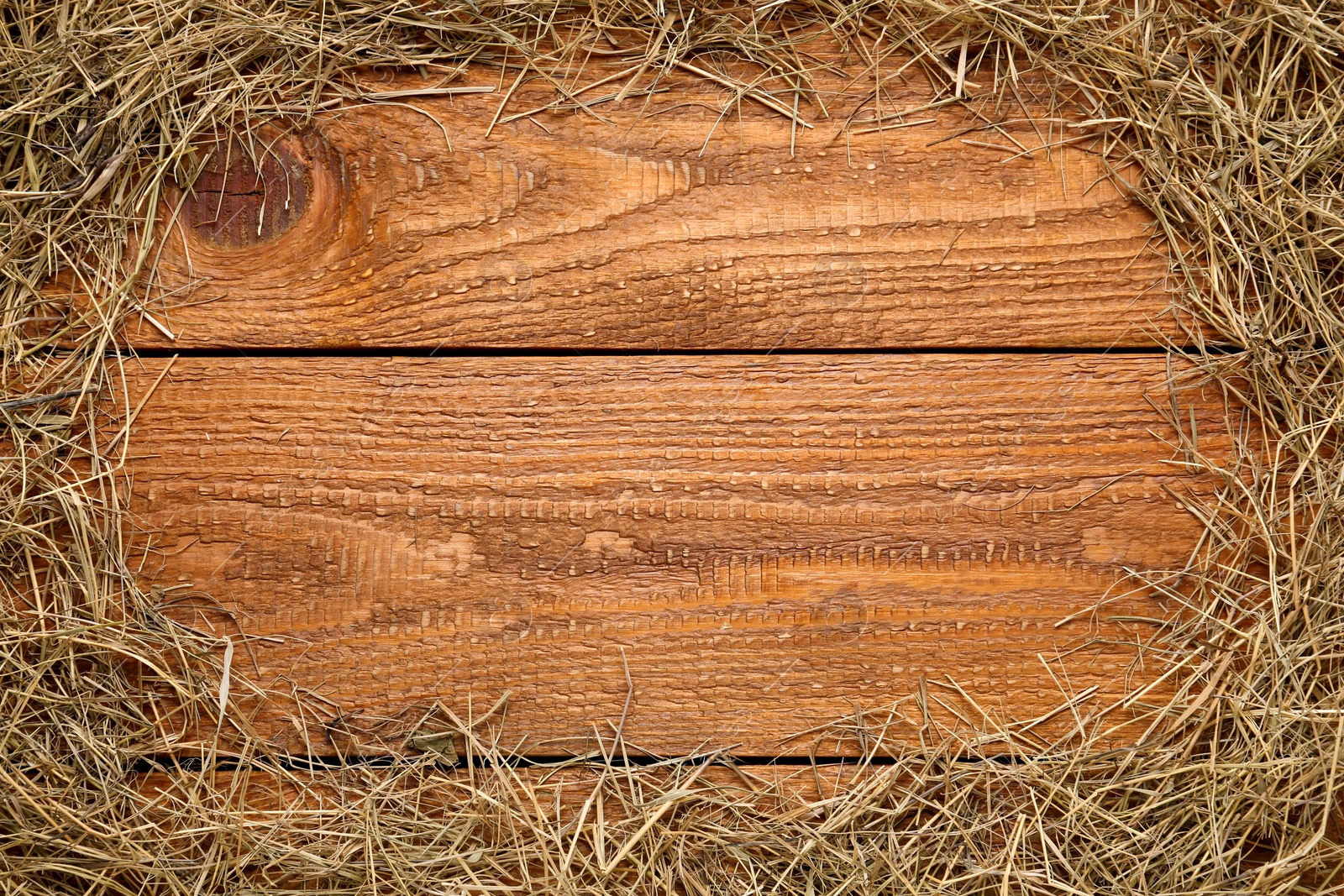 Photo of Frame made of dried hay on wooden background, top view. Space for text