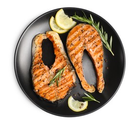 Photo of Plate with tasty salmon steaks, rosemary and lemon on white background, top view