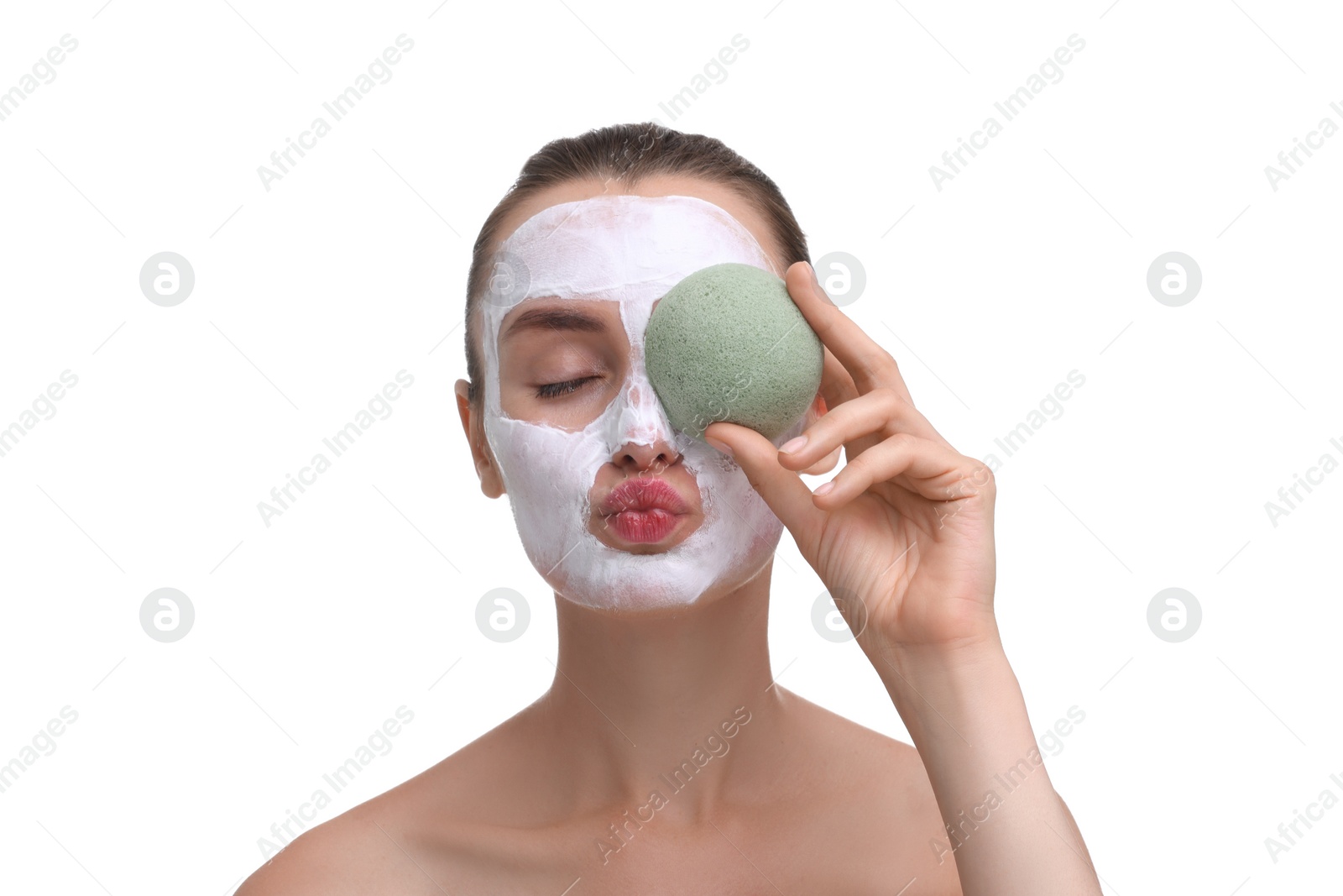 Photo of Happy young woman with face mask and sponge on white background