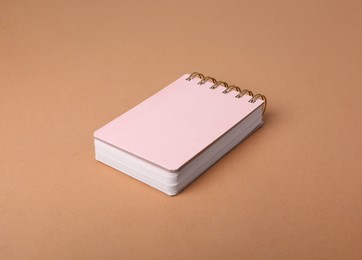 Photo of Closed office notebook on light brown background