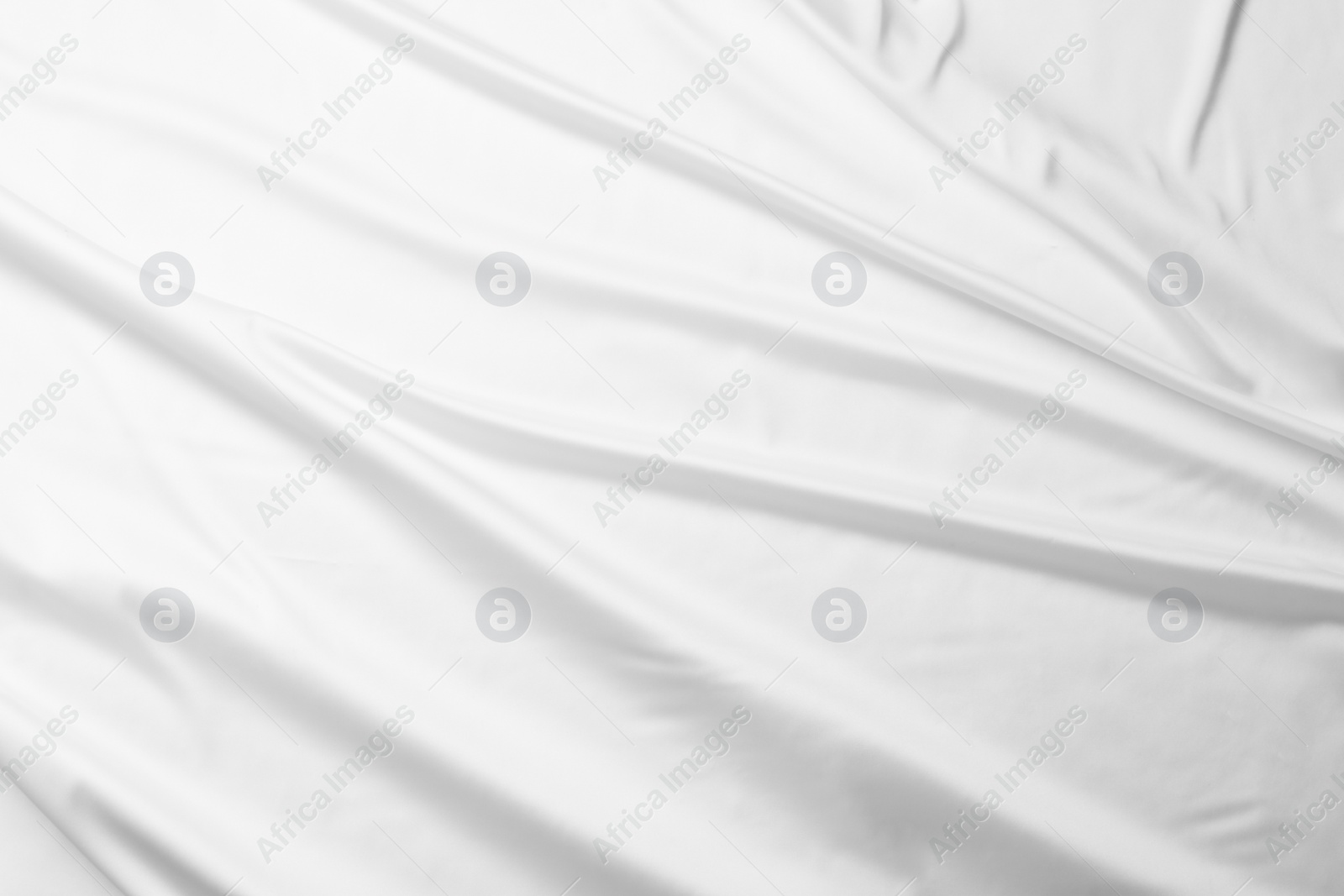 Photo of Texture of white silk ripple fabric as background, top view