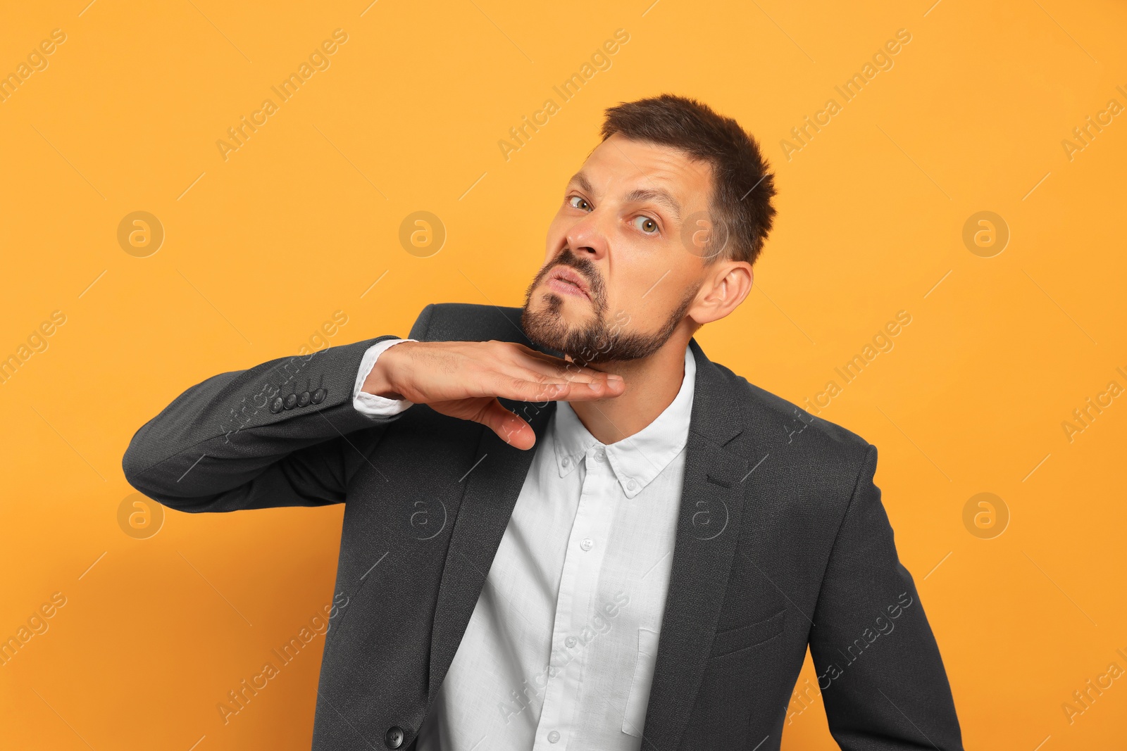 Photo of Aggressive man on orange background. hate concept